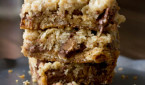 You will fall in love with these #Reeses Crumble bars. Buttery oatmeal cumble stuffed with chocolate chips and #Reesespeanutbuttercups ohsweetbasil.com_